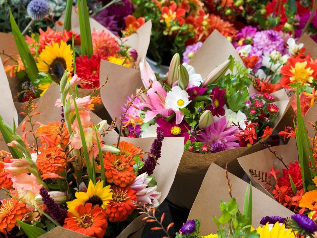 Local, seasonal mixed flowers wrapped in Kraft paper at the flower stand.